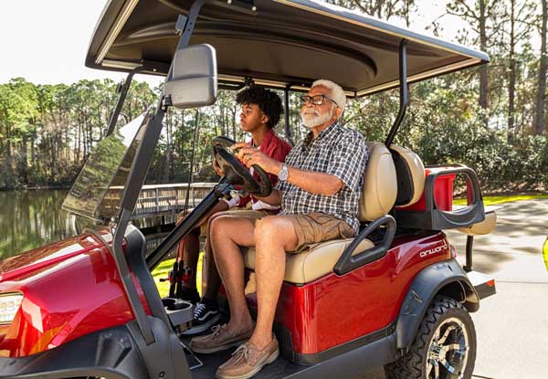 Red lifted golf cart father son fishing